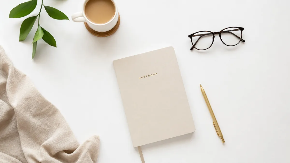 a neatly styled flat lay photography setup on a white surface with…