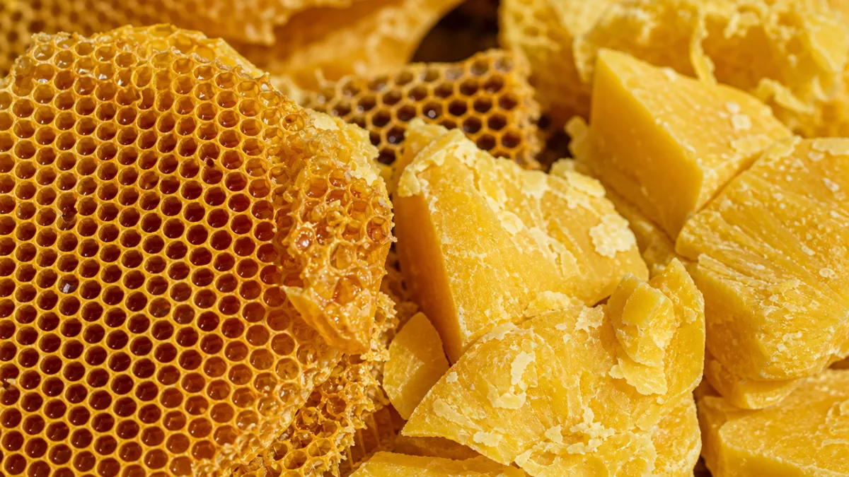 close-up of honeycomb and raw beeswax in natural daylight with golden warm…
