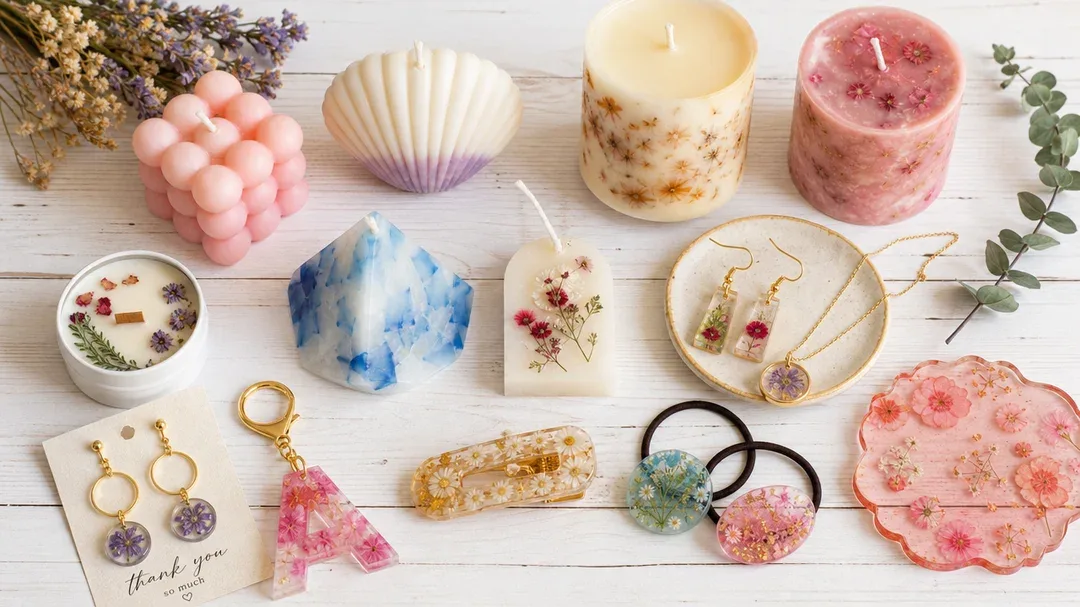 a flat lay of colorful handmade candles and resin jewelry on a…