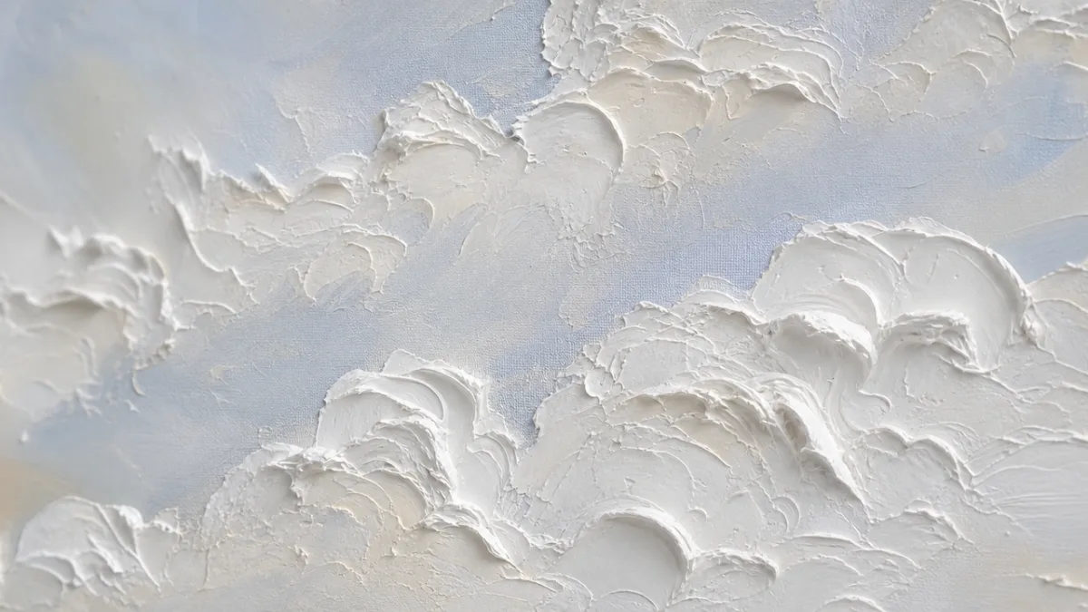 close-up of thick white acrylic paint applied with a palette knife on…