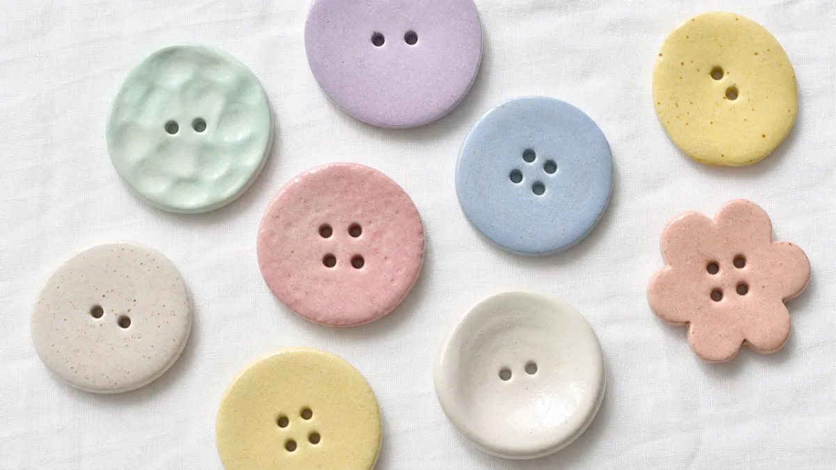 a flat lay of oversized handmade buttons in pastel colors on a…